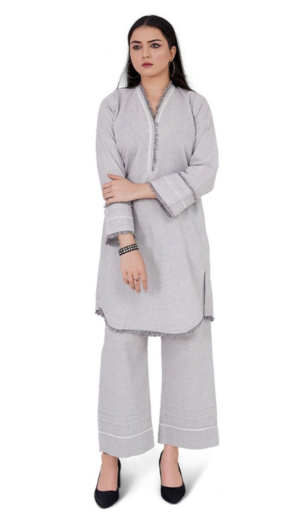 Woman wearing a gray outfit with a white background