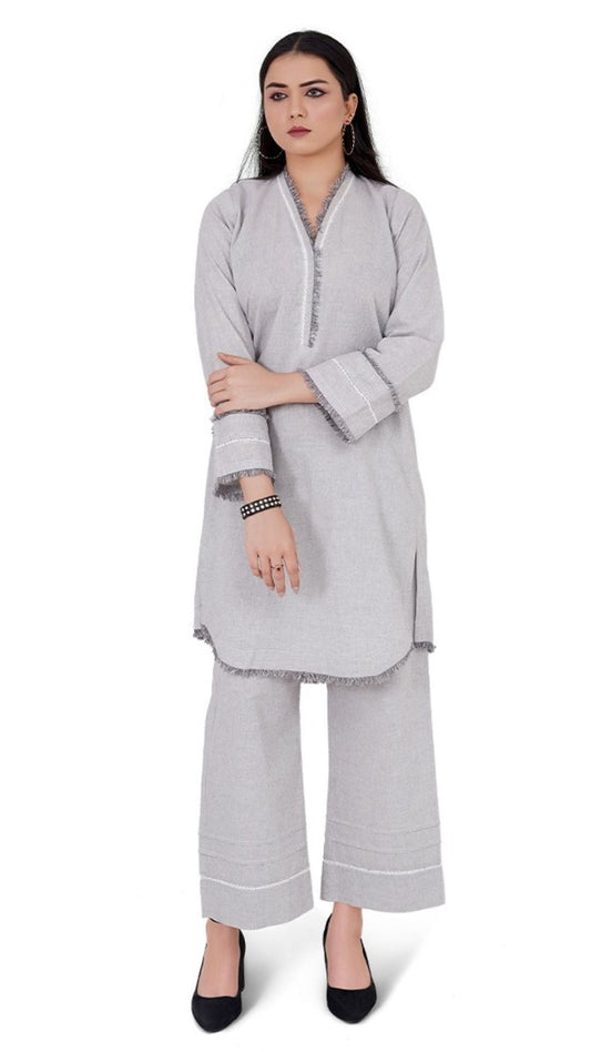 Woman wearing a gray outfit with a white background