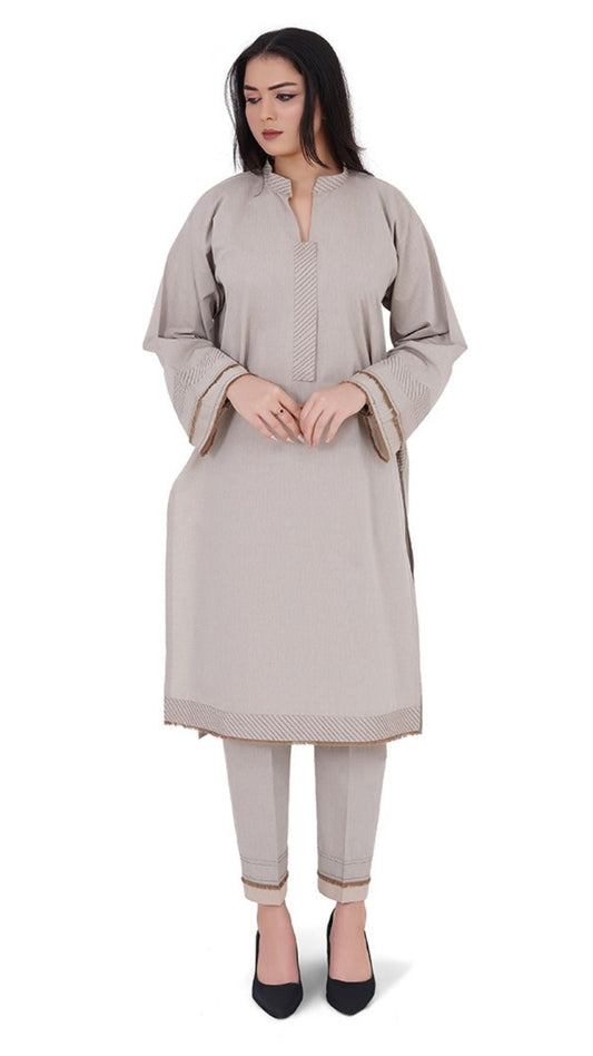Woman wearing a beige kurta with pants on a white background