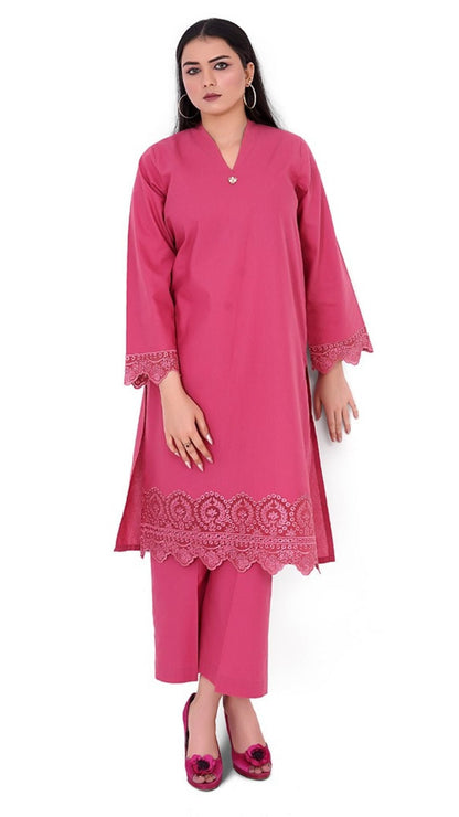 Woman wearing a pink kurta with lace details on a white background